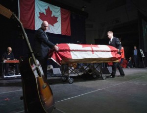 Casket bearing Stompin' Tom Conmors was wheeled across stage at his memorial service in Peterborough on March 13, 2013. -NEWS PHOTO
