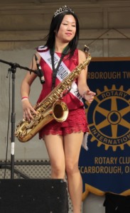 Kristen Au as Miss Canada Tourism on stage with sax at Canada Day concert in 2014 -kristenau.com