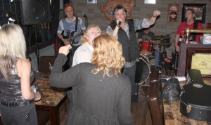 Tommy Rocker [singing], Earl Johnson [left] and Bill Petrie [right] get the girls dancing at one of his jams. -17