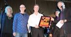 George beams receiving poster from co-emcees Roger Ashby & Joey Cee as Pete Otis and Cathy Young share the magic moment-17