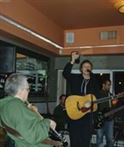 Lindy hoists a glass at a Relish Sunday jam in April of 2010 in a then-barren corner that is now a dedicated stage. -Gary 17