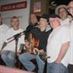 A group of talented musicians attending Sebastian Agnello's open stage received Winterfolk t-shirts one Monday in 2013.  Left to right: Harpin' Norm Lucien, club server Henke; Brian Gladstone; Herb Dale; Mark Denington; Brian Jantzi; Pete Otis -GARY 17