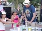 Mark Sepic works with kids in his impromptu instrument workshop. -GARY 17